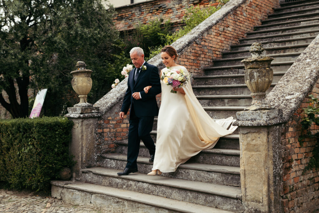 Bride and her dad walking down the stairs on the way to the ceremony