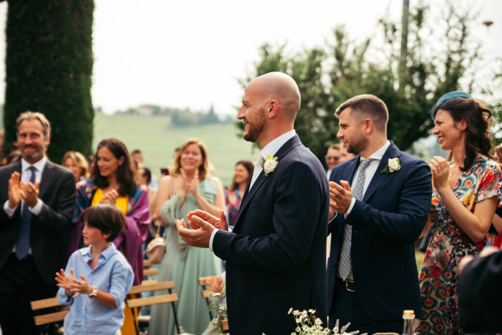 The groom smiles to the bride as she arrives