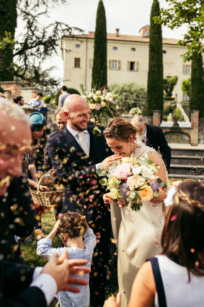 Bride and groom walk down the aisle together at Castello di Coazzolo in Piedmont