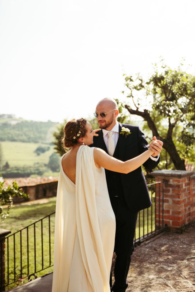 Bride and groom dancing in the scenic hills of the Langhe region