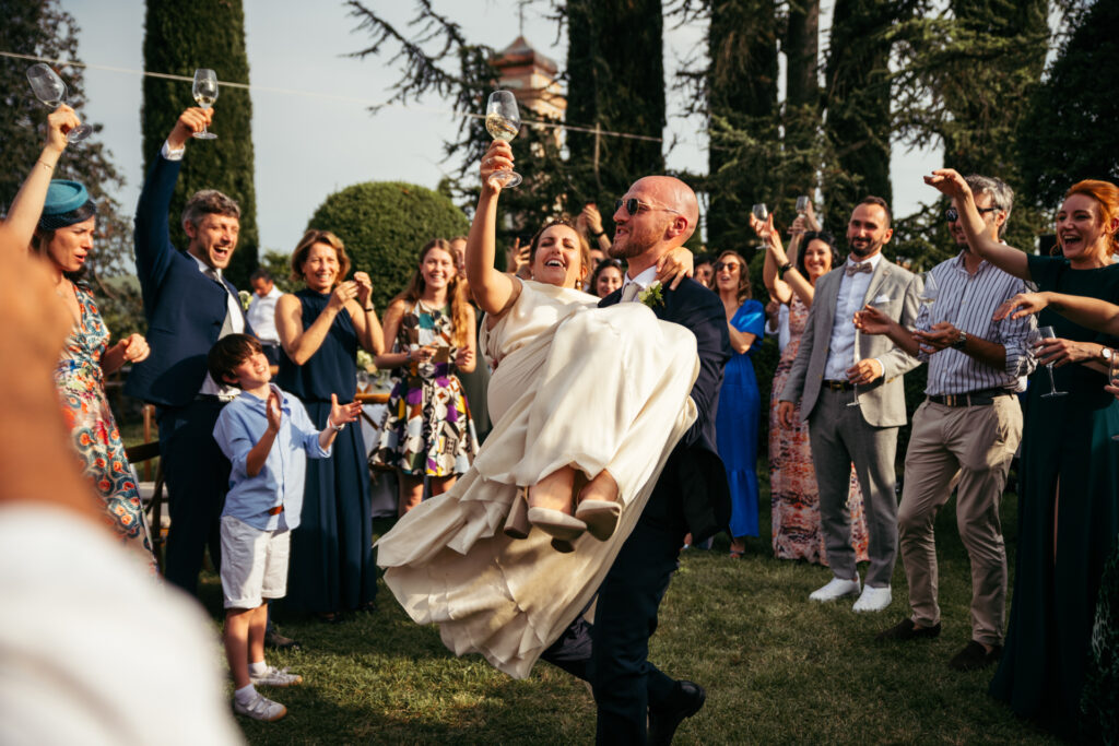 Bride and groom dancing and raising glasses at wedding reception in Piedmont