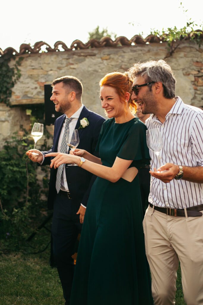 People smiling and raising glasses at wedding reception in Piedmont