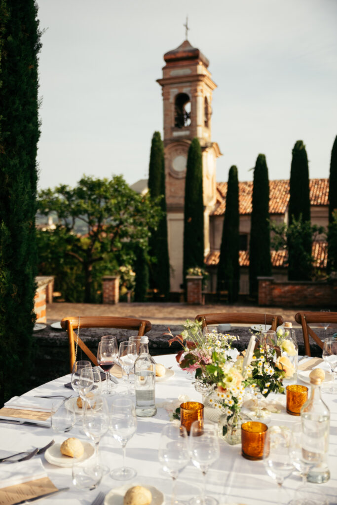 Close-up of elegant wedding table settings with local wine and flowers in Langhe