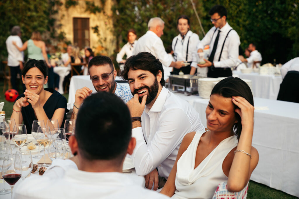 Guests smiling and talking to each other at the wedding reception