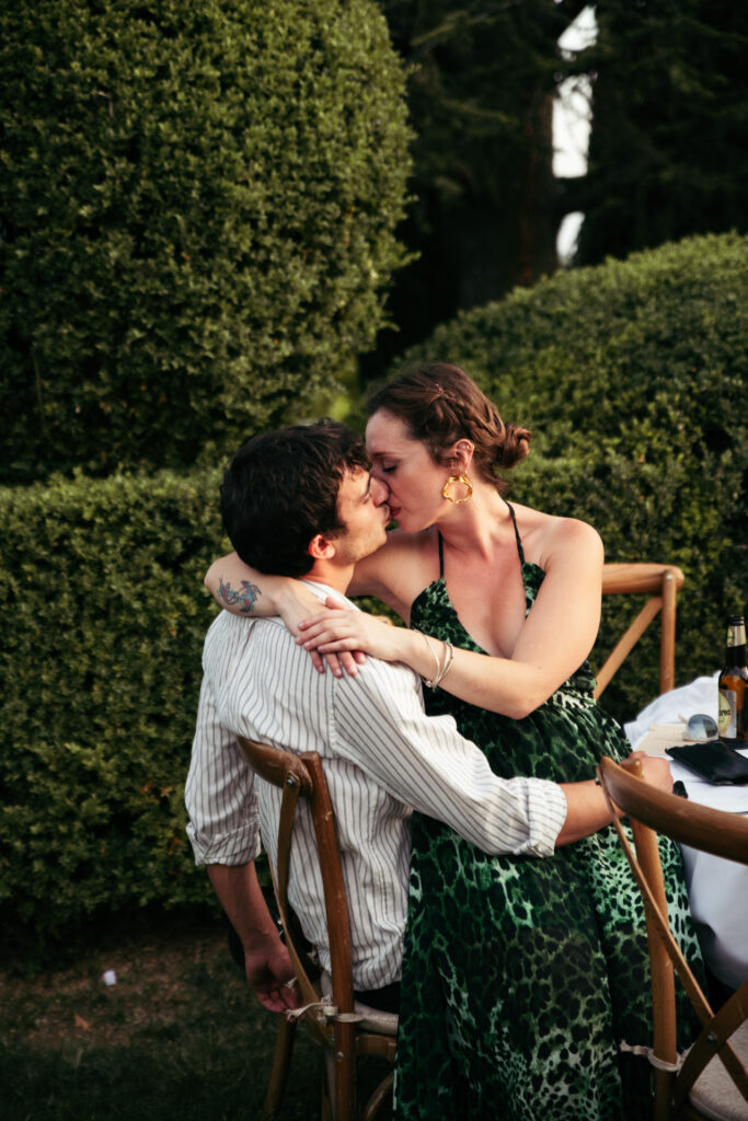 A couple of guests kissing during the wedding reception