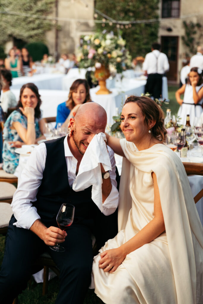 Bride and groom getting emotional while listening their guests making speeches to them