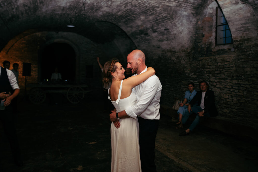 First dance for bride and groom in a wine cellar of Castello di Coazzolo