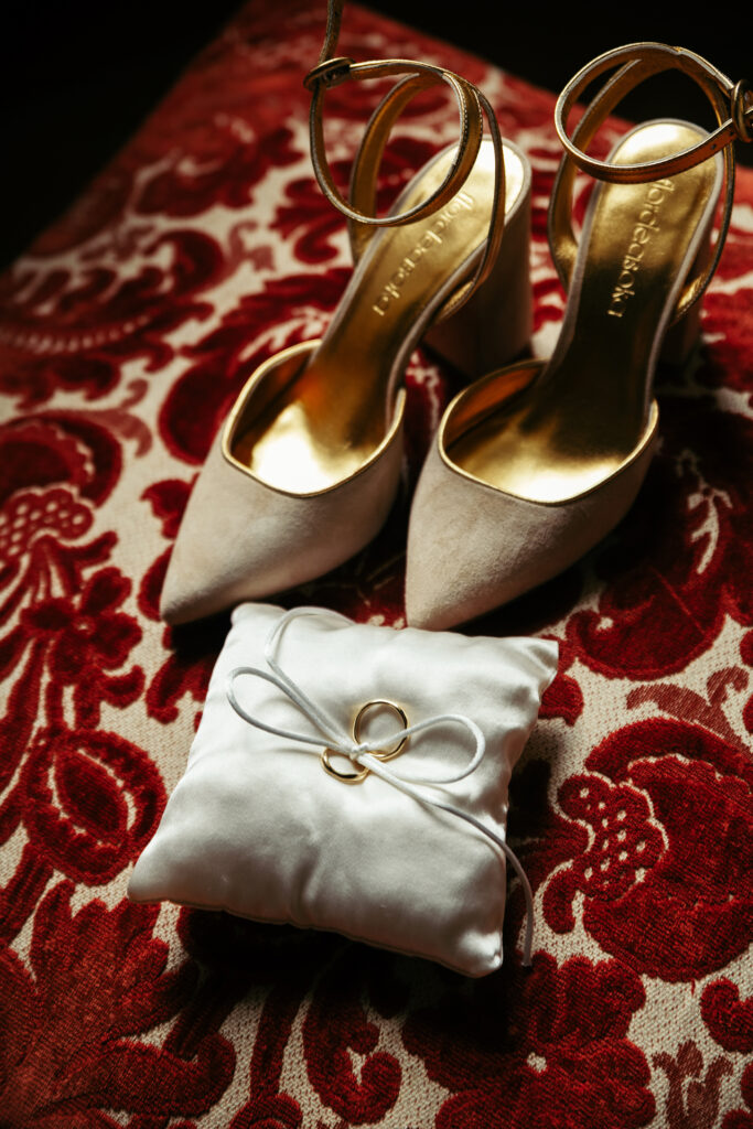 Bride shoes and wedding bands close-up