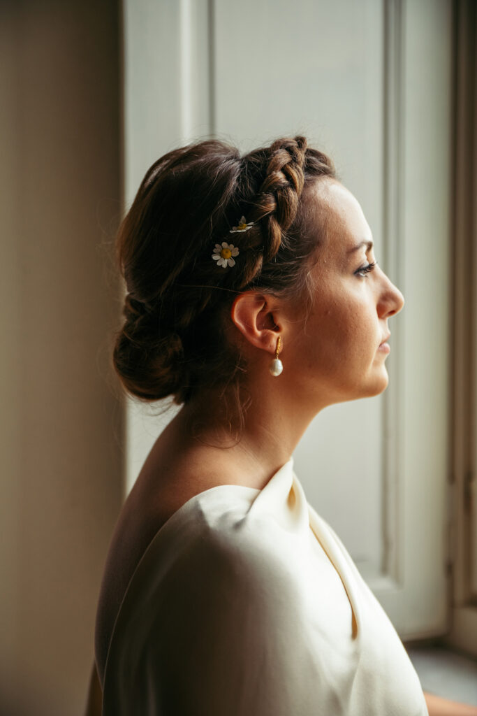 Portrait of the bride looking out of the window in Italy