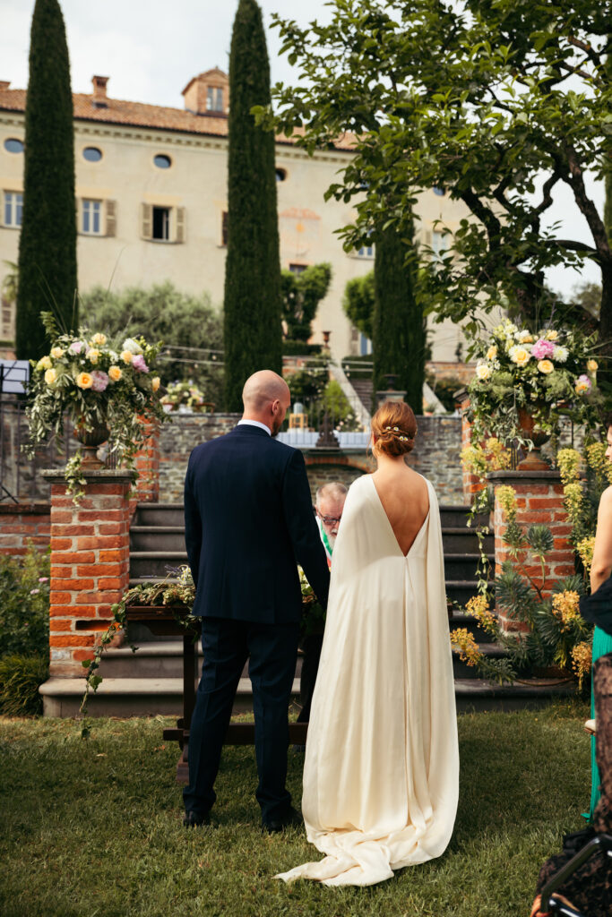 Bride and groom in front of the celebrant at the outdoor wedding ceremony