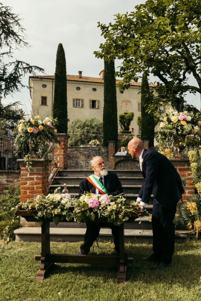 Groom talking to the celebrant before the ceremony begins