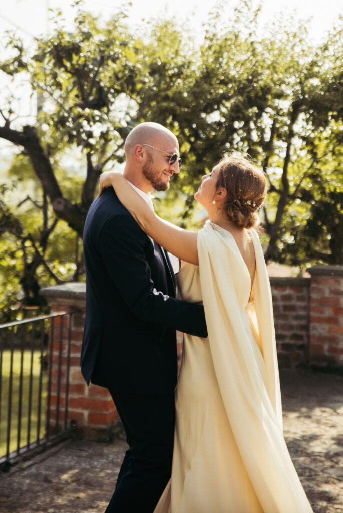 Bride and groom have a little dance alone against the countryside backdrop of Langhe region