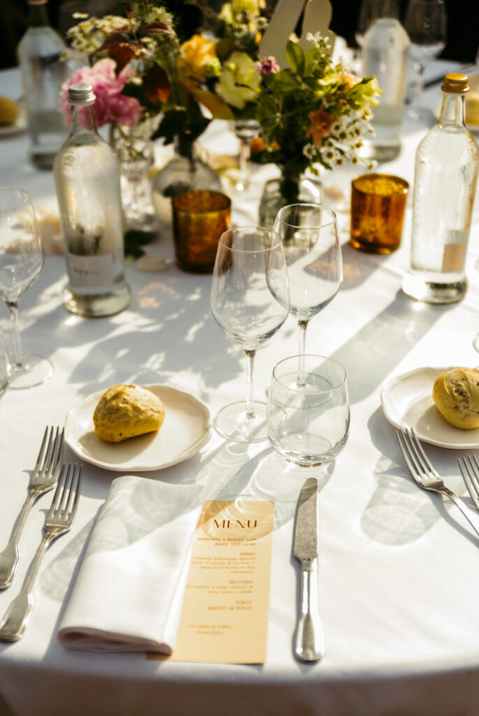 Table setup detail at sunset during the wedding reception in Piedmont Italy