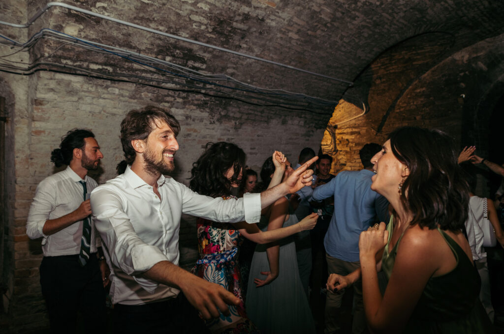 Guests dancing in a wine cellar at Castello di Coazzolo