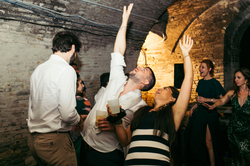 Guests partying in a wine cellar at Castello di Coazzolo