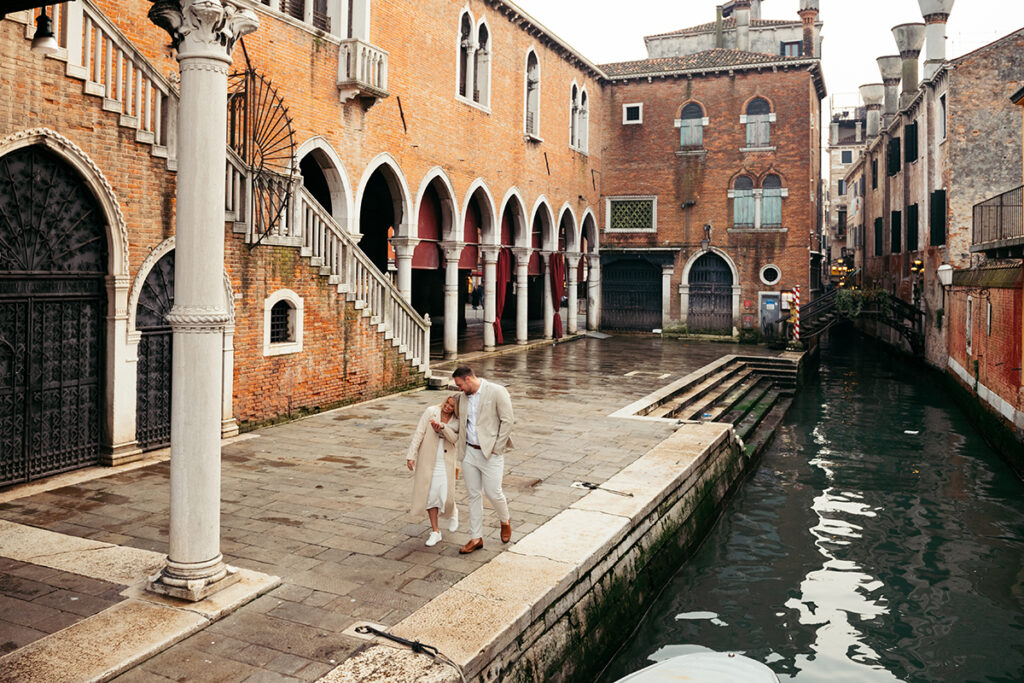 Couple walking and laughing at Rialto Market in Venice, Italy