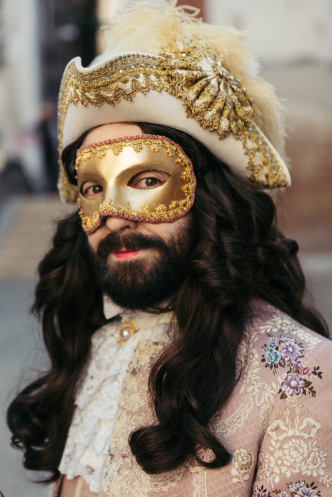 Venice Carnival portrait of a man in an 18th-century costume and golden mask