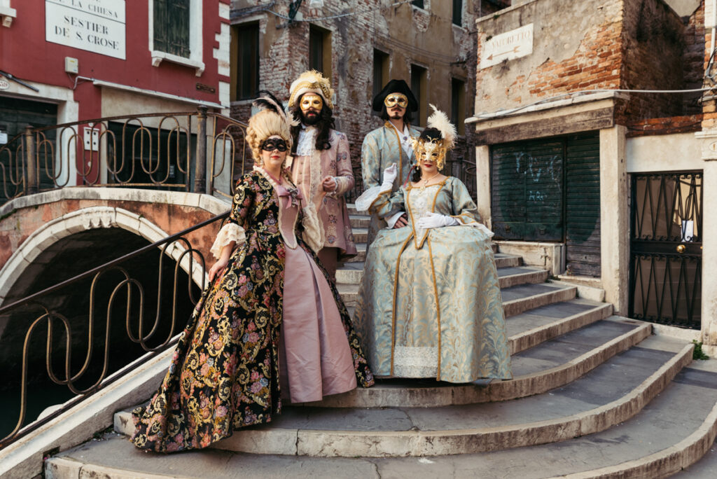 Venice Carnival photoshoot featuring two couples in elaborate historical costumes