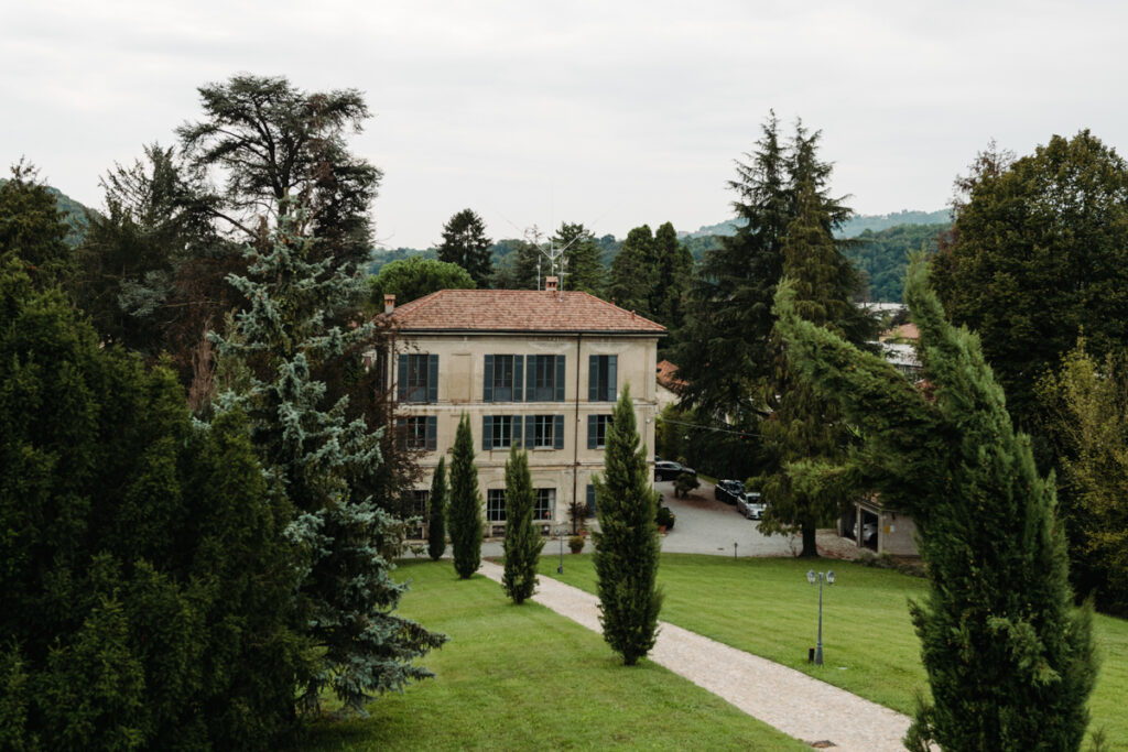 Scenic view of an Italian villa surrounded by tall cypress trees, perfect for an elegant elopement.