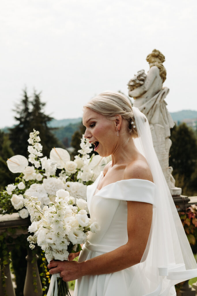 Bride looking down at her with surprise while the groom takes out his vows