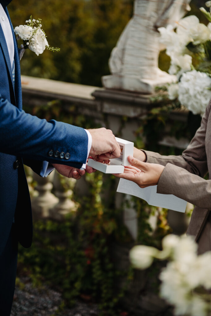 Close-up of the groom taking the ring from the celebrant