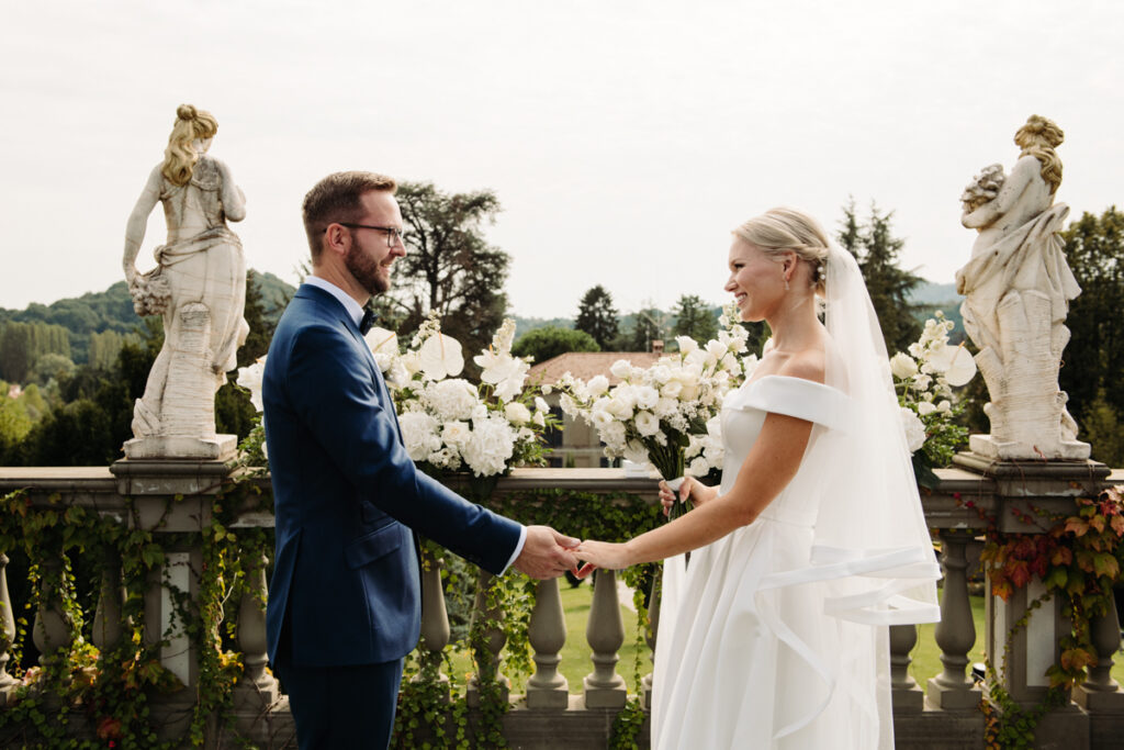 The couple holding hands smiling at each other after the symbolic ceremony.