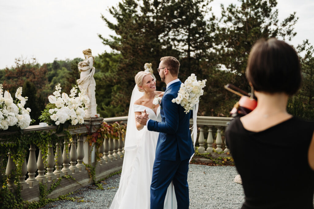 The couple dancing hand in hand, smiling after their intimate ceremony