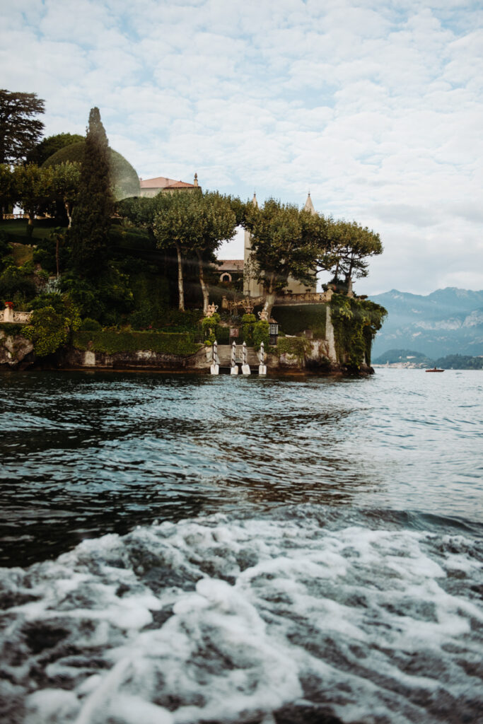 Scenic view of Villa del Balbianello surrounded by greenery on Lake Como