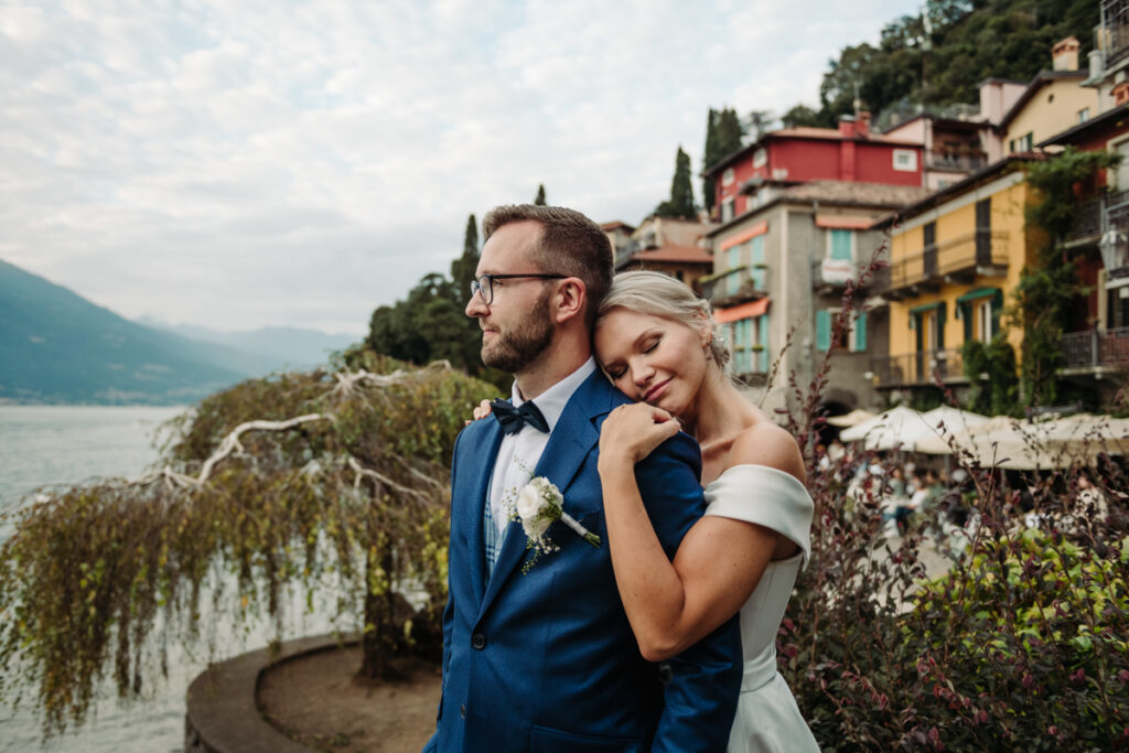 Bride resting her head on the groom’s shoulder in Varenna, smiling softly