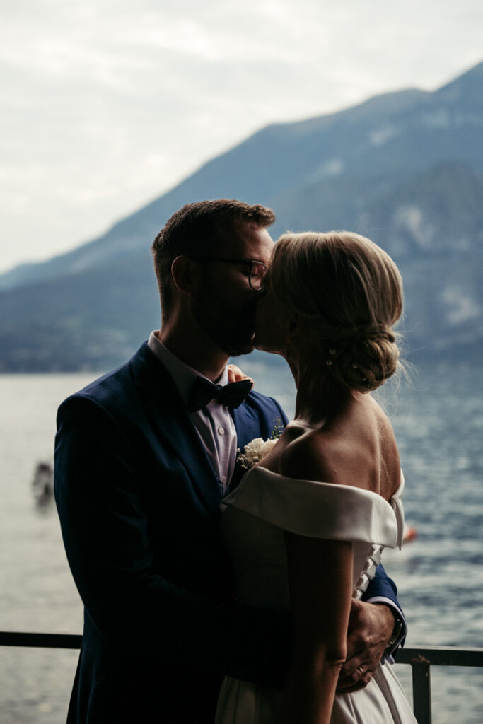 Intimate silhouette of the bride and groom sharing a tender moment at sunset