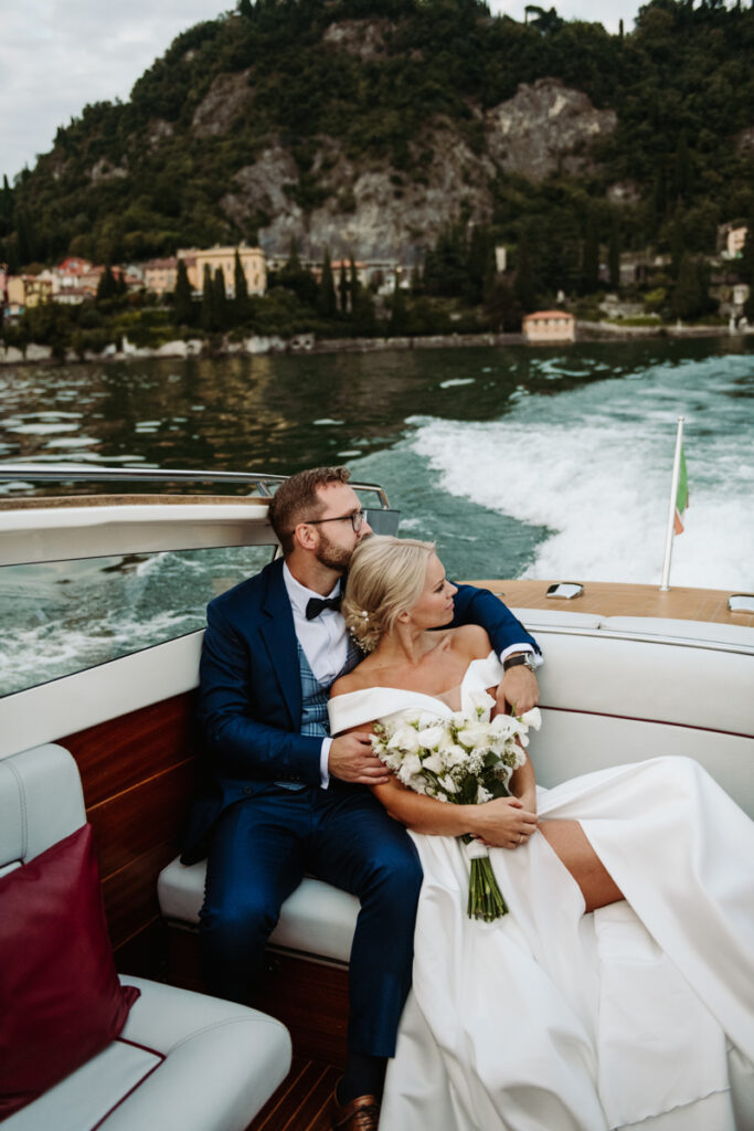 Groom and bride enjoying a peaceful boat trip on Lake Como.