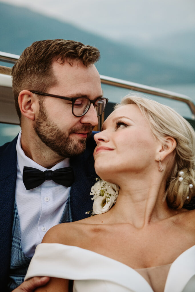 Groom looking lovingly at the bride during a tender moment on the boat