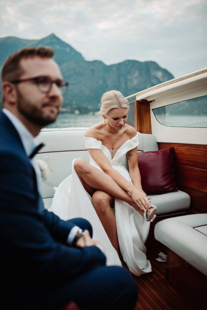 Bride putting on her shoes before getting off the boat