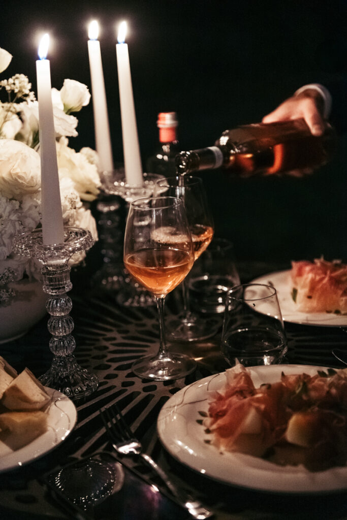 Close-up of wine being poured during a romantic candlelit dinner