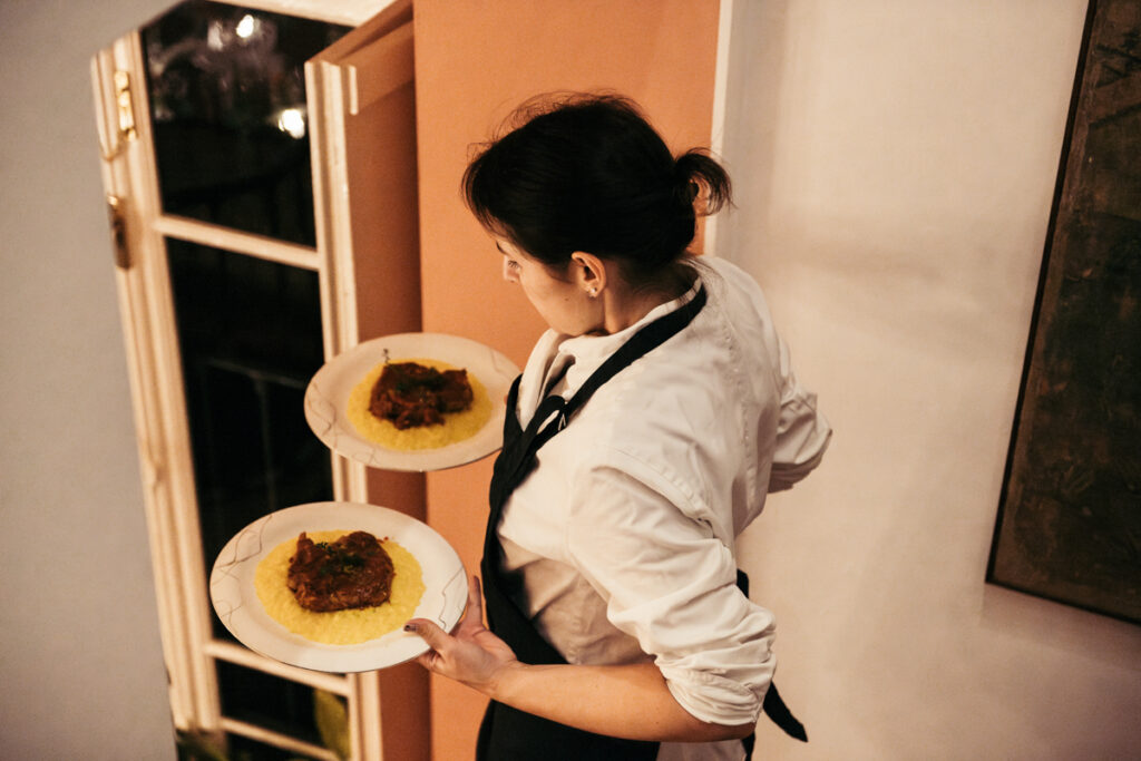 Chef serving traditional Italian dishes for the wedding dinner