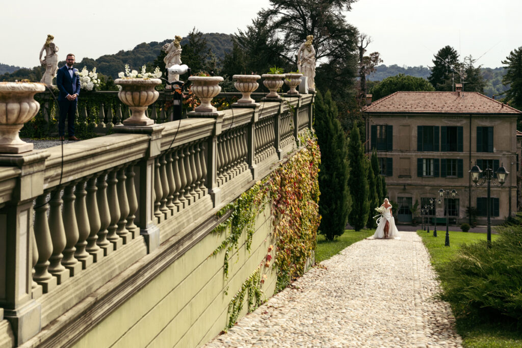 Bride walking down a stone pathway surrounded by lush gardens during her intimate elopement