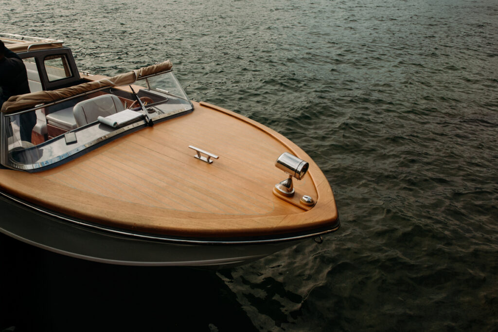 Close-up of a wooden vintage boat floating on the waters of Lake Como