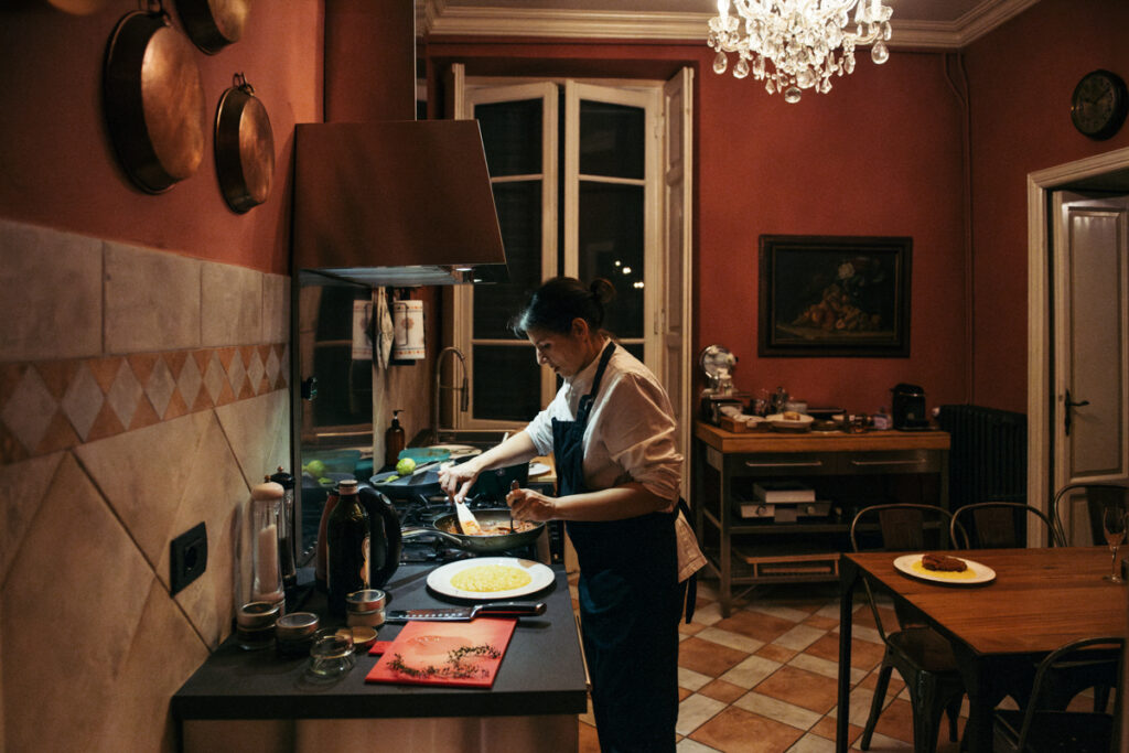 Chef preparing traditional Italian dishes in a cozy kitchen