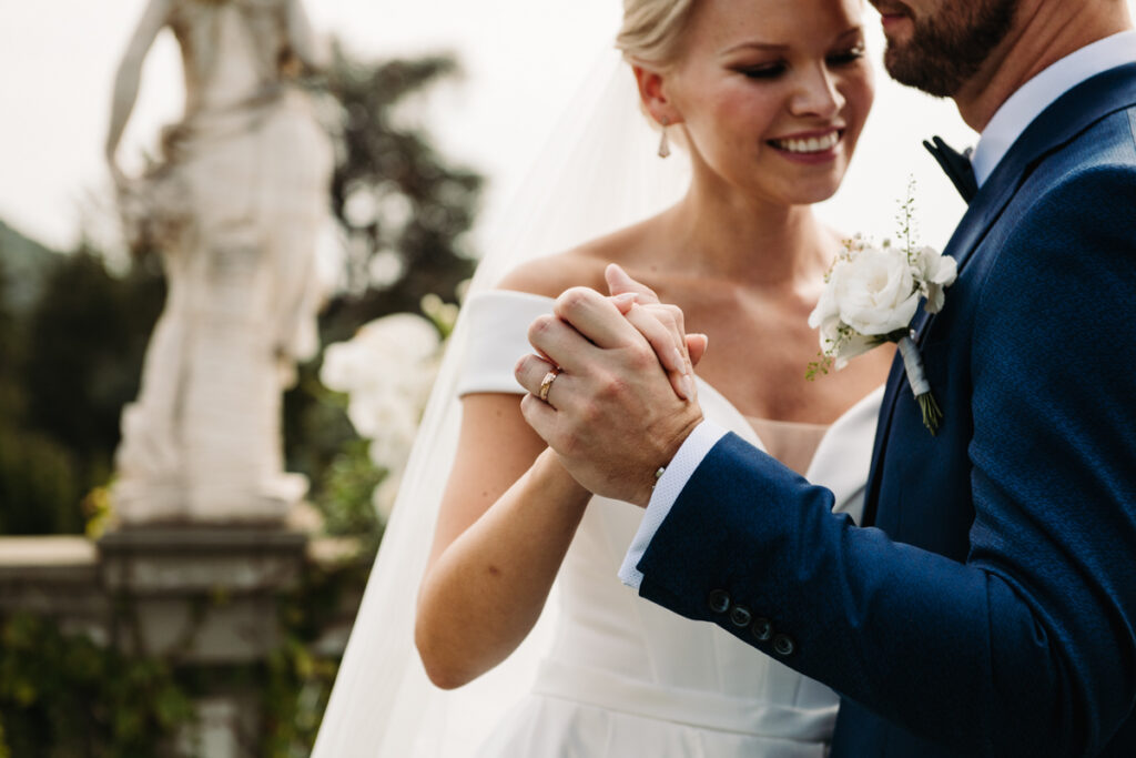 Close-up of bride and groom dancing together outdoors