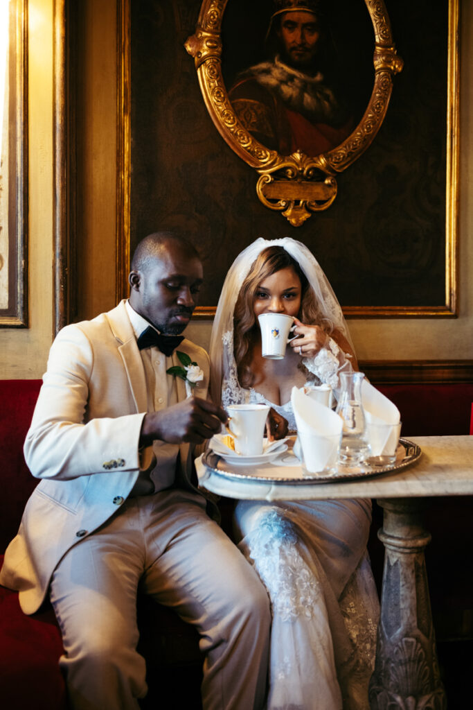 Newlyweds enjoying coffee together in an elegant Venetian café.