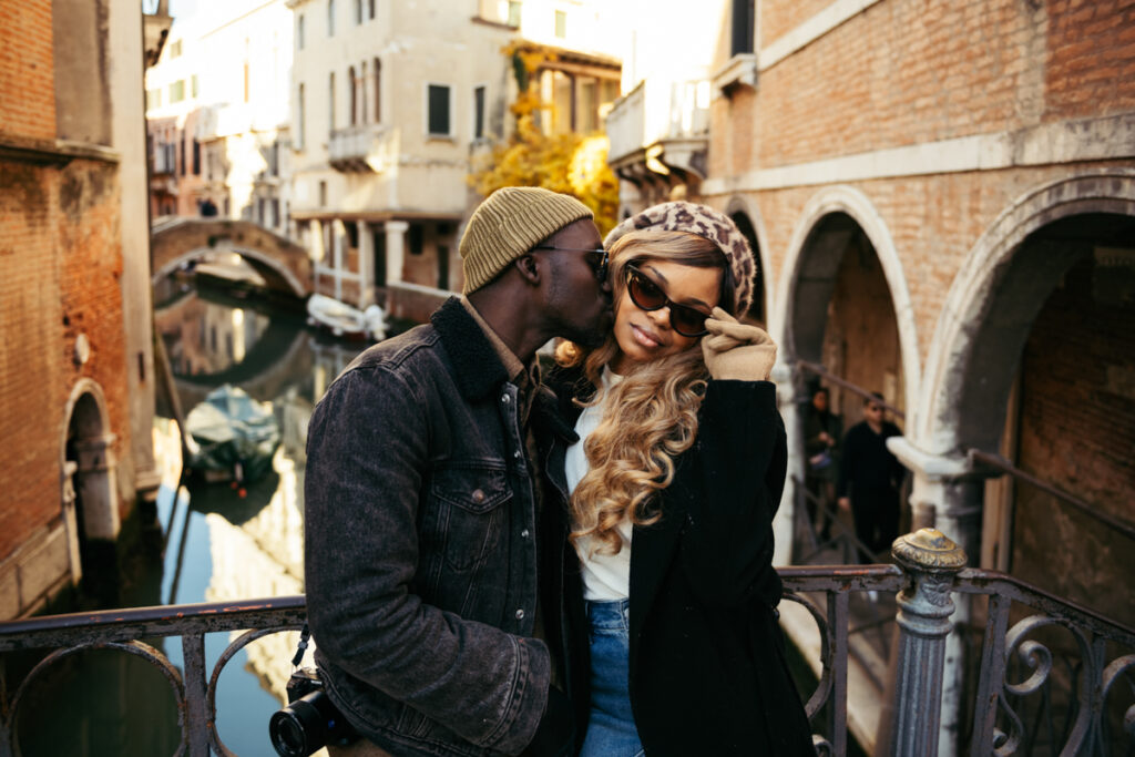 Couple posing for a photoshoot on a bridge in Venice