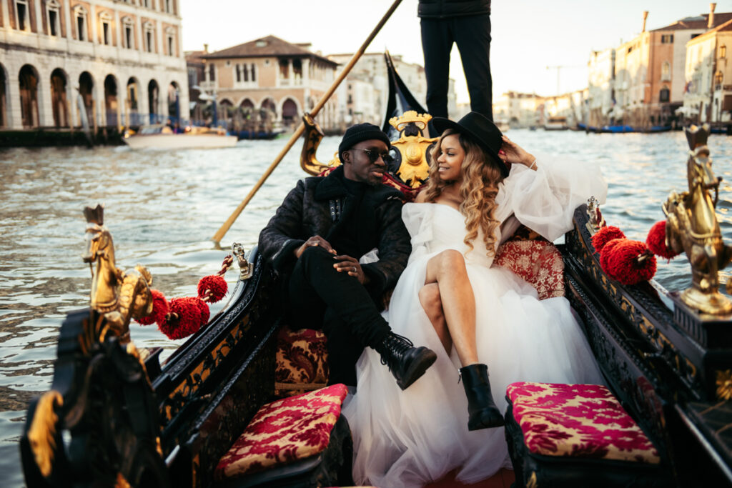 Bride and groom relaxing in a gondola, soaking in the Venice atmosphere.