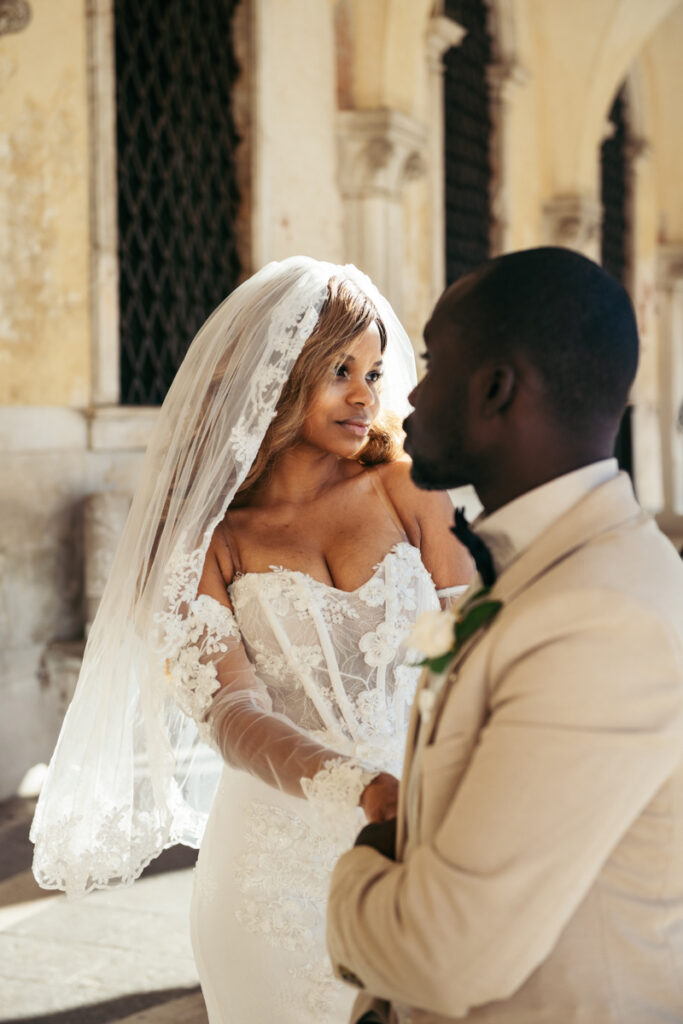 Intimate moment between a newlywed couple in Venice.