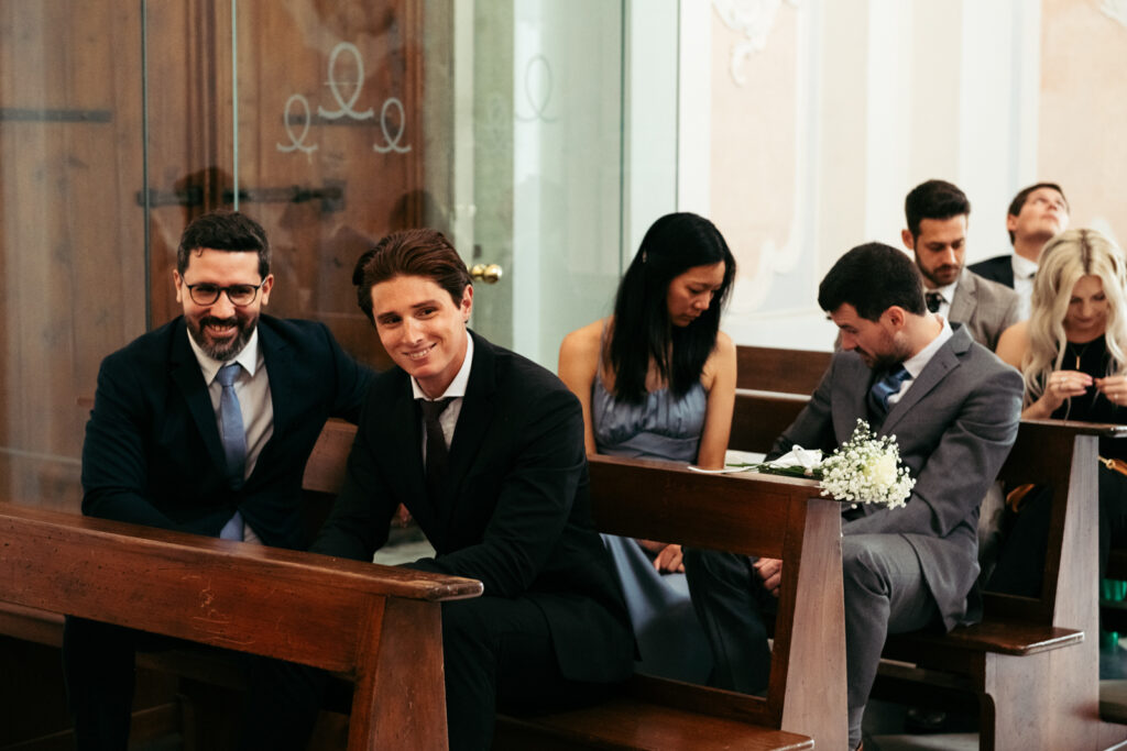 Guests seated in the chapel before the Italy micro-wedding ceremony begins.