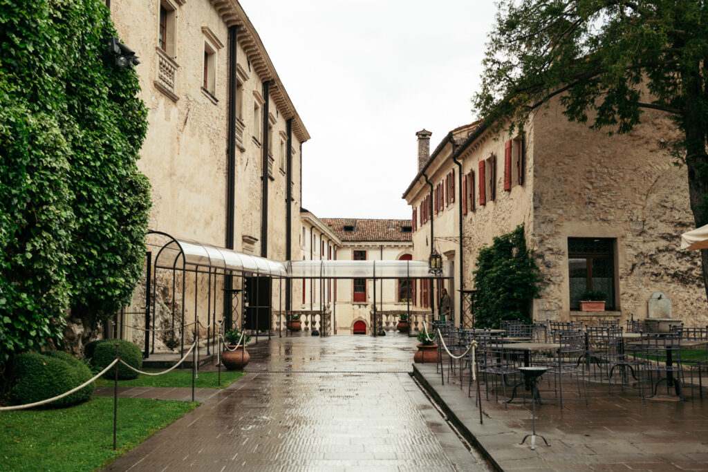 Rainy courtyard view of CastelBrando—a romantic, quiet setting for an Italy destination wedding.
