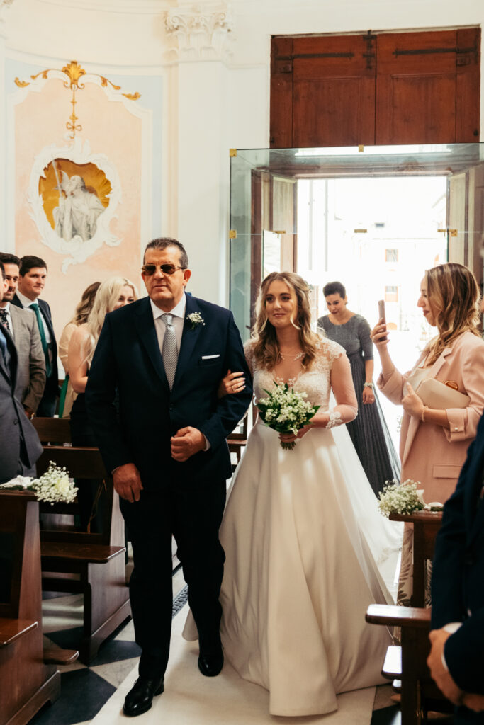 Bride walking down the aisle with her father at the start of the ceremony.