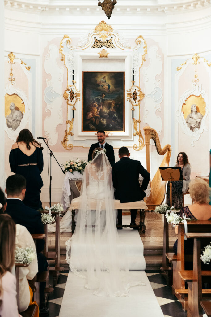 Bride and groom standing at the altar during their intimate ceremony in a castle chapel.
