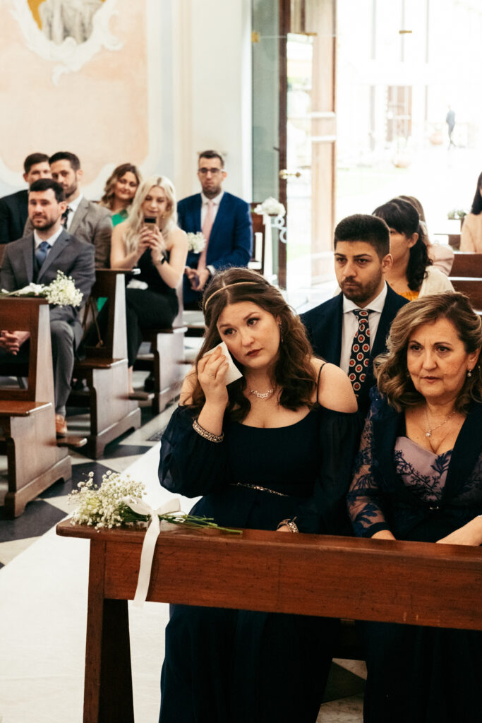 Wedding guests attending the ceremony inside the chapel at CastelBrando