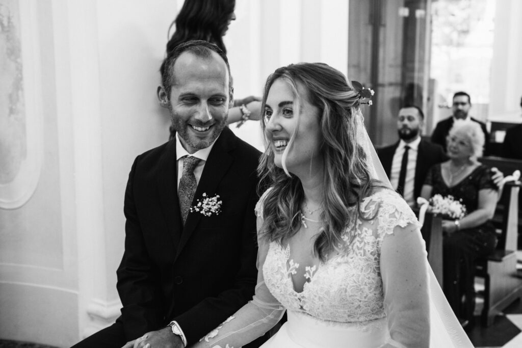 Black and white portrait of the bride and the groom during the ceremony in CastelBrando chapel