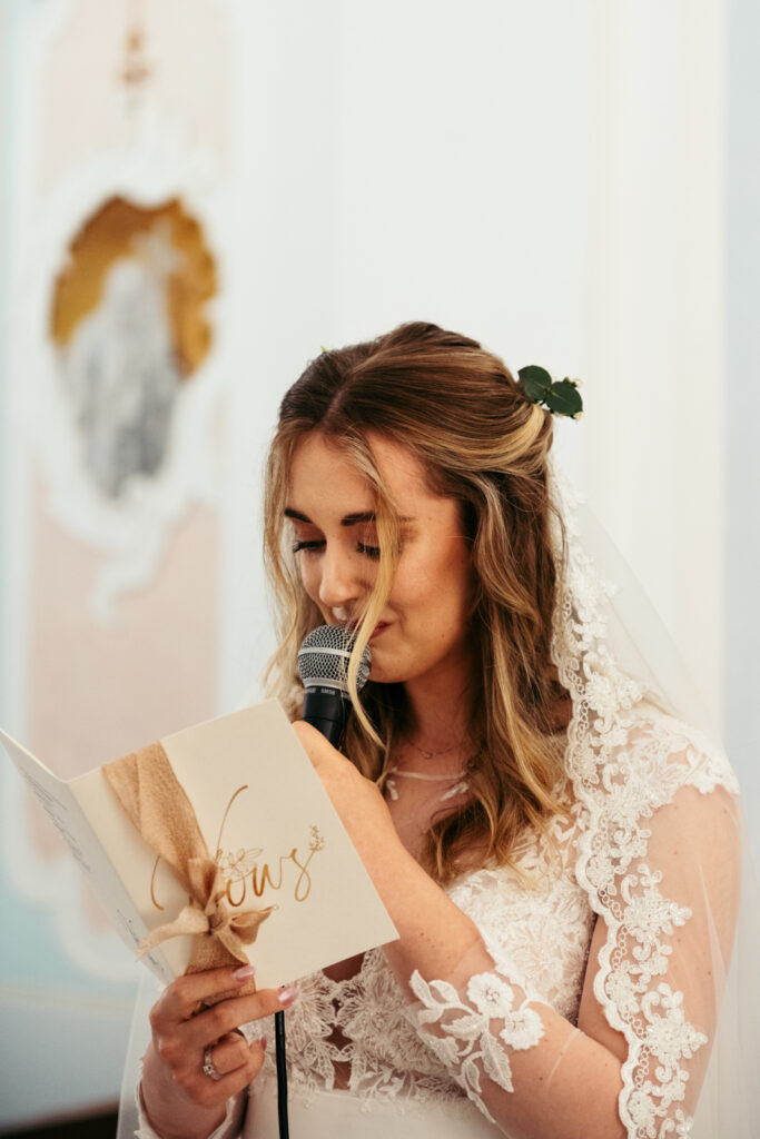 Bride reading her personal vows with emotion during her Italy micro-wedding ceremony.